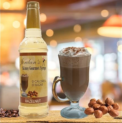 Bottle of Jordan's Skinny Gourmet Syrup Hazelnut next to a glass of hot chocolate with whipped cream.